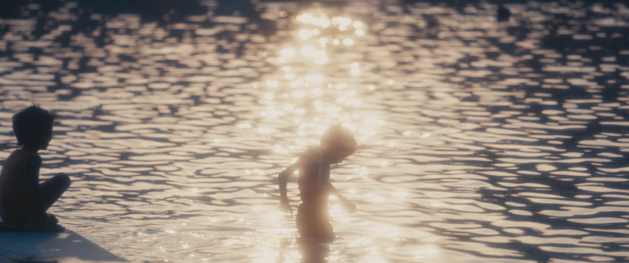 silhouette of a child in water