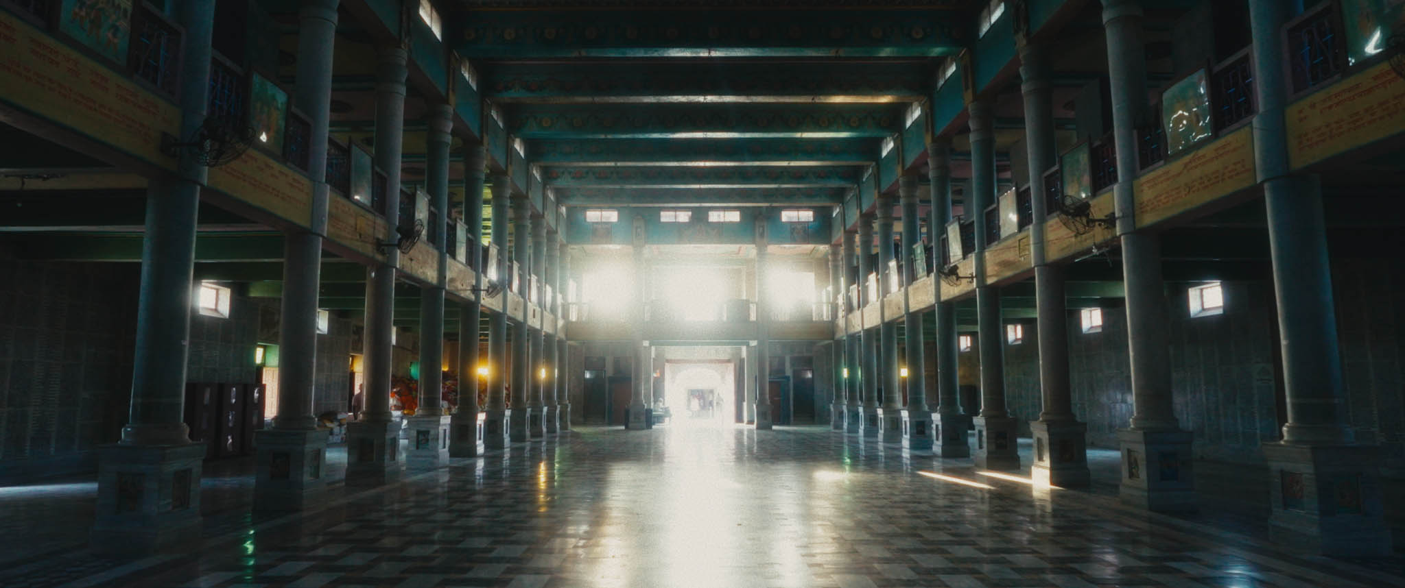 Inside a building with pillars and marble floor